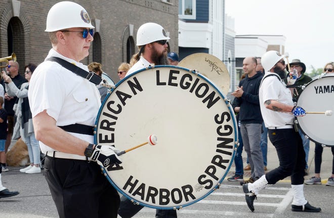 An American Legion drumline marches in a parade.